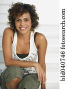 South American woman sitting on stairs