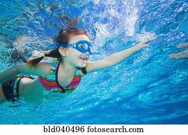 Underwater shot of Asian girl swimming