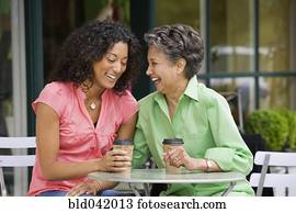African American mother and adult daughter laughing