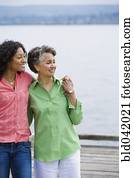 African American mother and adult daughter hugging