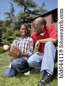 African father and son with baseball glove