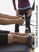 Asian man stretching on exercise equipment