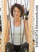 Senior woman sitting in exercise equipment