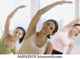 Three young women in yoga class