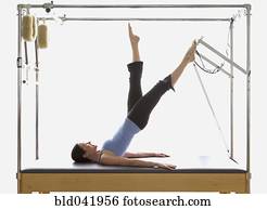 Woman stretching on exercise equipment