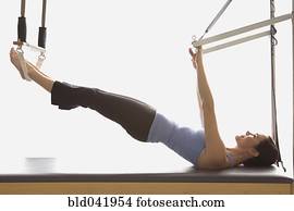 Woman stretching on exercise equipment