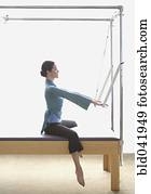 Woman stretching on exercise equipment