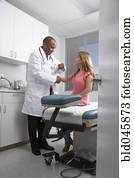 African American male doctor examining patient