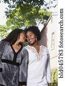 African American mother and daughter smiling at each other