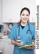 Hispanic female medical professional holding chart