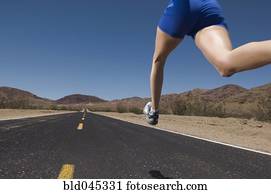 Mixed Race woman running on road
