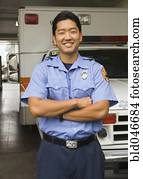 Asian male paramedic in front of ambulance