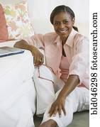 Senior African American woman next to laptop