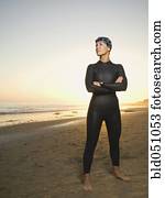 Hispanic woman wearing wetsuit and goggles