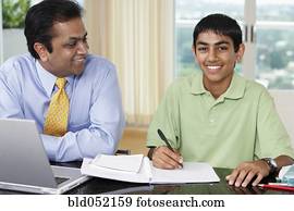 Middle Eastern father helping son with homework