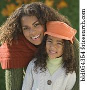 African mother hugging daughter