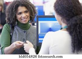African woman paying with credit card