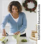 African woman wrapping gift