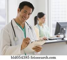 Asian male doctor holding chart