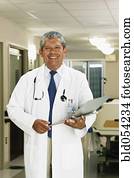 Hispanic male doctor holding chart