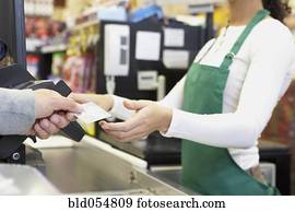 Man paying with credit card at grocery store