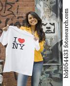 Mixed Race woman holding t-shirt