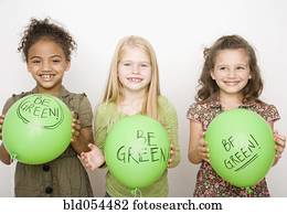 Multi-ethnic girls holding green balloons Multi-ethnic girls holding green balloons
