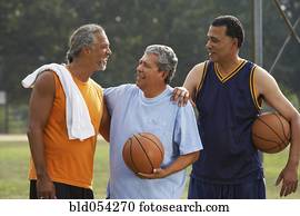 Multi-ethnic men holding basketballs
