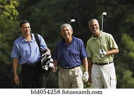 Multi-ethnic men playing golf