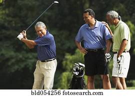 Multi-ethnic men playing golf