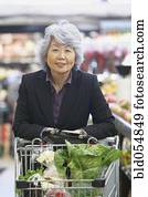 Senior Asian woman in grocery store