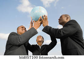 African businesspeople holding up globe