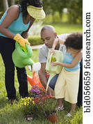 African family watering flowers