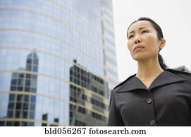 Asian businesswoman in front of high-rise
