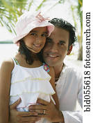 Hispanic father and daughter hugging