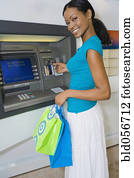Hispanic woman using atm