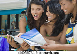 Hispanic women looking at magazine