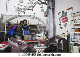 Multi-ethnic couple looking in salon window