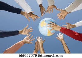 Multi-ethnic hands reaching for globe ball