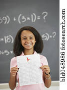 African American girl holding up A paper