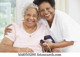 African American mother and adult daughter smiling at each other
