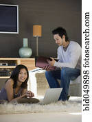 Asian couple working at home