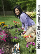 Hispanic woman gardening