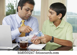 Middle Eastern father and son counting money