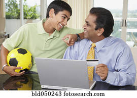 Middle Eastern father and son shopping online