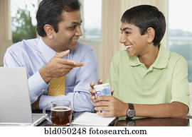 Middle Eastern father and son smiling at each other