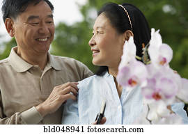 Senior Asian couple pruning flowers Senior Asian couple pruning flowers