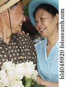 Senior Asian couple smiling at each other Senior Asian couple smiling at each other
