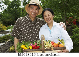Senior Asian couple with basket of vegetables Senior Asian couple with basket of vegetables
