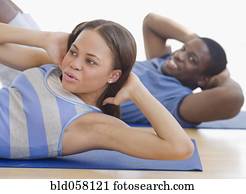 African couple exercising on mats